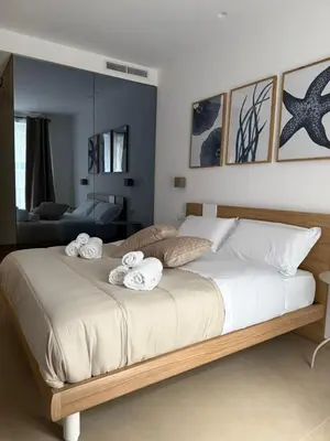 a bedroom with a large bed with towels on it at Santa Rosalia Suites in Palermo