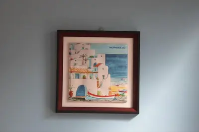 a picture on a wall with a picture of a beach at Casa Vacanze Verdemare in Mondello