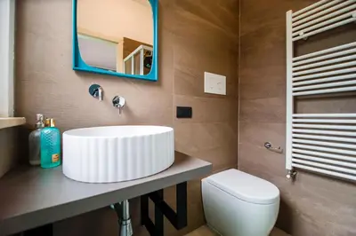 a bathroom with a white sink and a toilet at Casa Vacanze Verdemare in Mondello