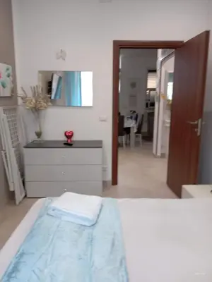 a bedroom with a bed and a dresser and a mirror at Dolce casa in Palermo