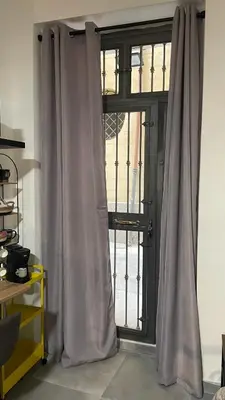 a door with curtains in front of a window at T&F Casa al Capo - In centro a Palermo in Palermo