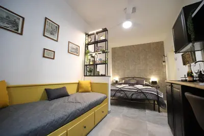 a small bedroom with a bed and a television at T&F Casa al Capo - In centro a Palermo in Palermo