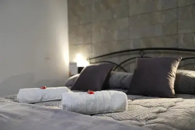 two beds with towels and pillows on top of them at T&F Casa al Capo - In centro a Palermo in Palermo