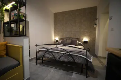 a bedroom with a bed and a brick wall at T&F Casa al Capo - In centro a Palermo in Palermo