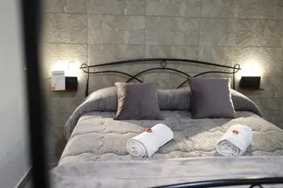 a bedroom with a bed with two towels on it at T&F Casa al Capo - In centro a Palermo in Palermo
