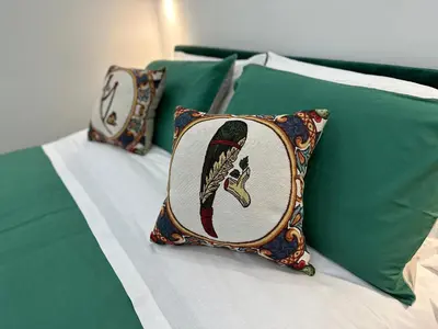 a bed with two pillows on top of it at Kàlia Rooms in Palermo