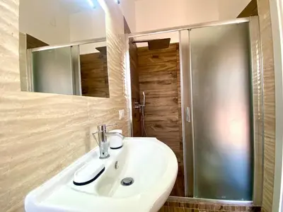 a bathroom with a white sink and a shower at Villa Grace, beach 200 meters away, independent in Alcamo