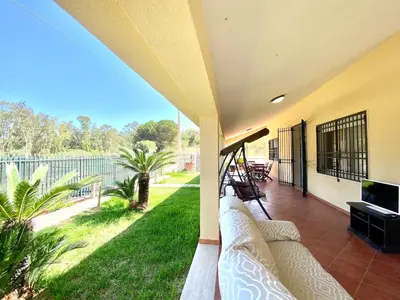 a porch with a couch and a view of a yard at Villa Grace, beach 200 meters away, independent in Alcamo