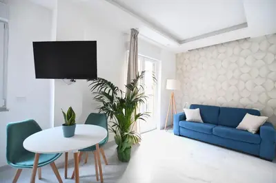 a living room with a blue couch and a table at iFlat Casa Diamante in Palermo