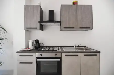 a kitchen with a sink and a stove top oven at iFlat Casa Diamante in Palermo