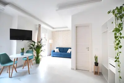a living room with a blue couch and a table at iFlat Casa Diamante in Palermo