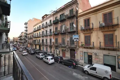 a busy city street with cars parked on the street at iFlat Casa Diamante in Palermo