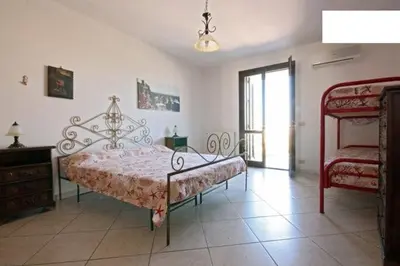 a bedroom with a large bed and a window at Pompei in Castellammare del Golfo