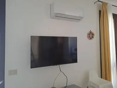a flat screen tv hanging on a wall at Pompei in Castellammare del Golfo
