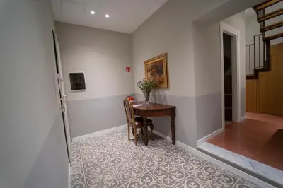 a hallway with a table with a vase of flowers at Il Tesoretto 1 in Palermo