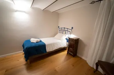 a small bedroom with a bed and a night stand at Il Tesoretto 1 in Palermo