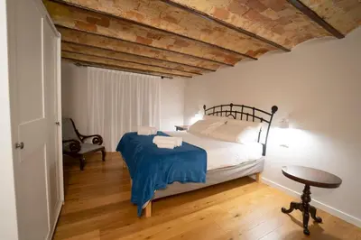 a bedroom with a bed and a wooden floor at Il Tesoretto 1 in Palermo