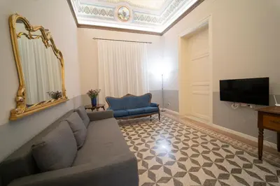 a living room with a couch and a tv at Il Tesoretto 2 in Palermo