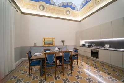 a dining room with a table and chairs at Il Tesoretto 2 in Palermo