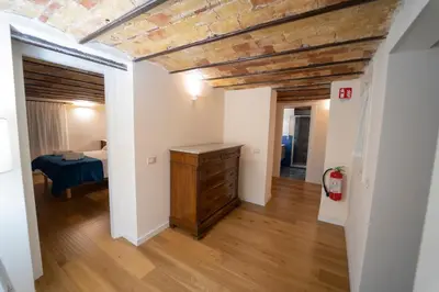 a bedroom with a bed and a wooden dresser at Il Tesoretto 2 in Palermo
