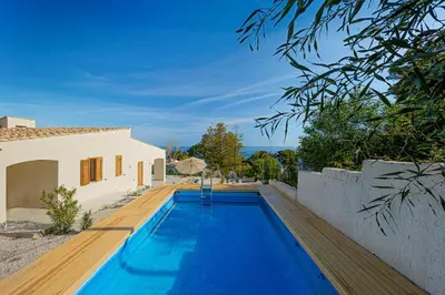 a swimming pool in the backyard of a house at Villa Four by Sicily Travelling Villas in Scopello
