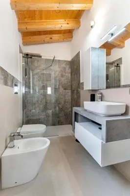 a bathroom with two sinks and a toilet and a shower at Le Piccole Duse in Palermo