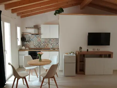 a kitchen with a table and chairs in a room at Le Piccole Duse in Palermo