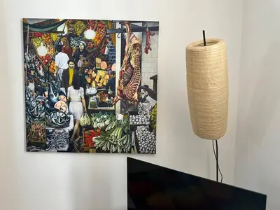 a painting hanging on a wall next to a lamp at Soraya House Next quattrocanti in Palermo