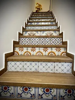 a staircase with blue and white tiles on the stairs at Il carrettiere in Termini Imerese