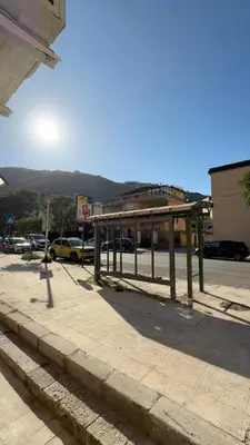 a bus stop on the side of a street at My Life in Palermo