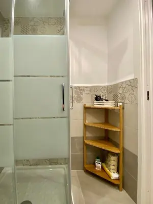 a shower with a glass door in a bathroom at A Casa di Jimmy in Palermo