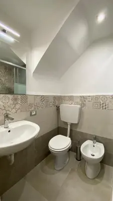 a bathroom with a toilet and a sink at A Casa di Jimmy in Palermo