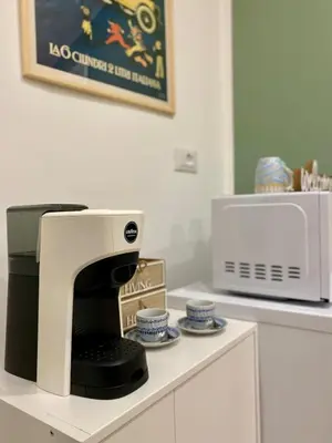 a coffee machine sitting on a counter next to a microwave at A Casa di Jimmy in Palermo