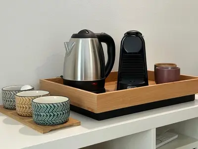affeepot and cups on a wooden tray on a shelf at Pirandello 181 in Palermo