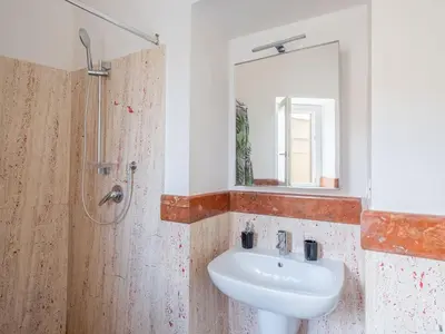 a kitchen with a white refrigerator and a microwave at Apartment in Villa Storica Lanterna sul Mare Palermo in Palermo
