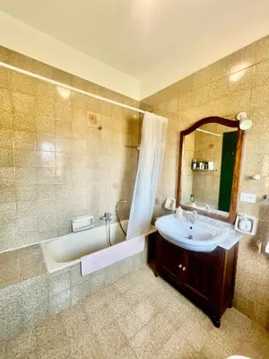 a bathroom with a tub and a sink and a mirror at Villa Donna Toni in Carini
