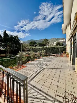a walkway outside of a building with mountains in the background at Villa Donna Toni in Carini