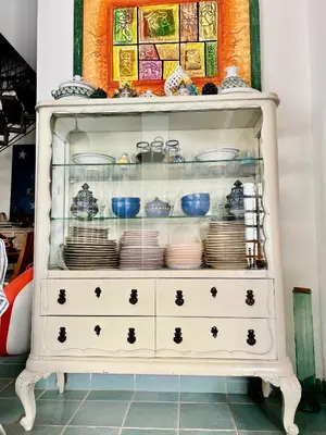 a white dresser with plates and dishes on it at Villa Donna Toni in Carini