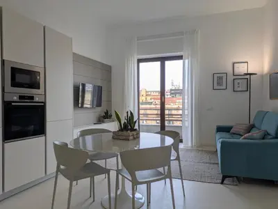a living room with a table and a blue couch at Apartament and suite cavour 106 in Palermo