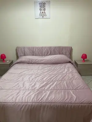 a bedroom with a bed with a purple comforter at Alle spalle della cattedrale in Palermo
