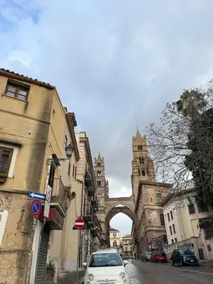 a white car parked in front of a building with a gate at Vicoletto Ludovica - Proppro SRL- Palermo in Palermo