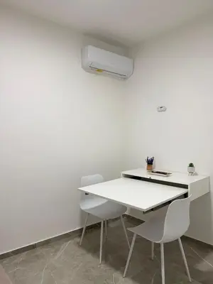 a white table and chairs in a white room at Vicoletto Ludovica - Proppro SRL- Palermo in Palermo