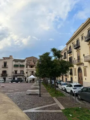 a parking lot with cars parked in front of buildings at Vicoletto Ludovica - Proppro SRL- Palermo in Palermo