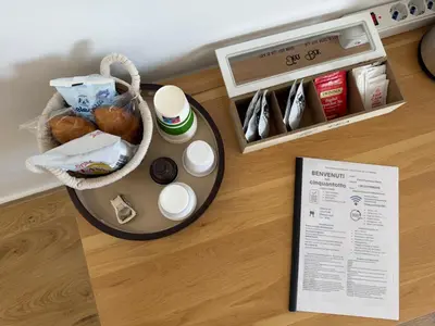 a table with a basket of food and a pamphlet at Cinquantotto Cozy Rooms in Palermo