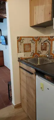 a kitchen with a sink and a counter top at Palazzo Conte Federico Apartments in Palermo