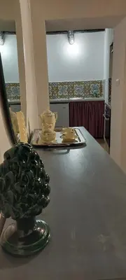 a table with a green pineapple sitting on top of it at Palazzo Conte Federico Apartments in Palermo