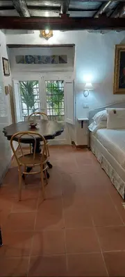 a room with a table and a bed and a bedroom at Palazzo Conte Federico Apartments in Palermo