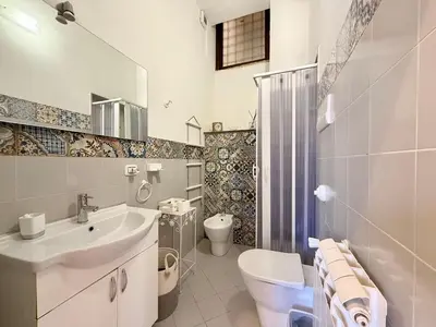 a bathroom with a sink and a toilet and a shower at La Rosa Bianca della Vucciria in Palermo