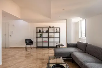 a living room with a couch and a chair at Ruggero City View apartment by Wonderful Italy in Palermo