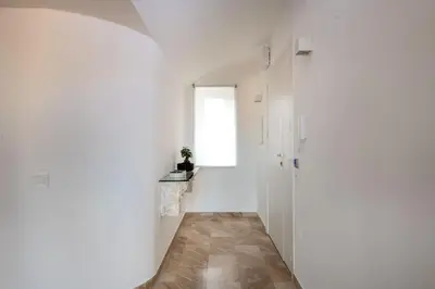 a hallway with a white wall and a window at Ruggero City View apartment by Wonderful Italy in Palermo